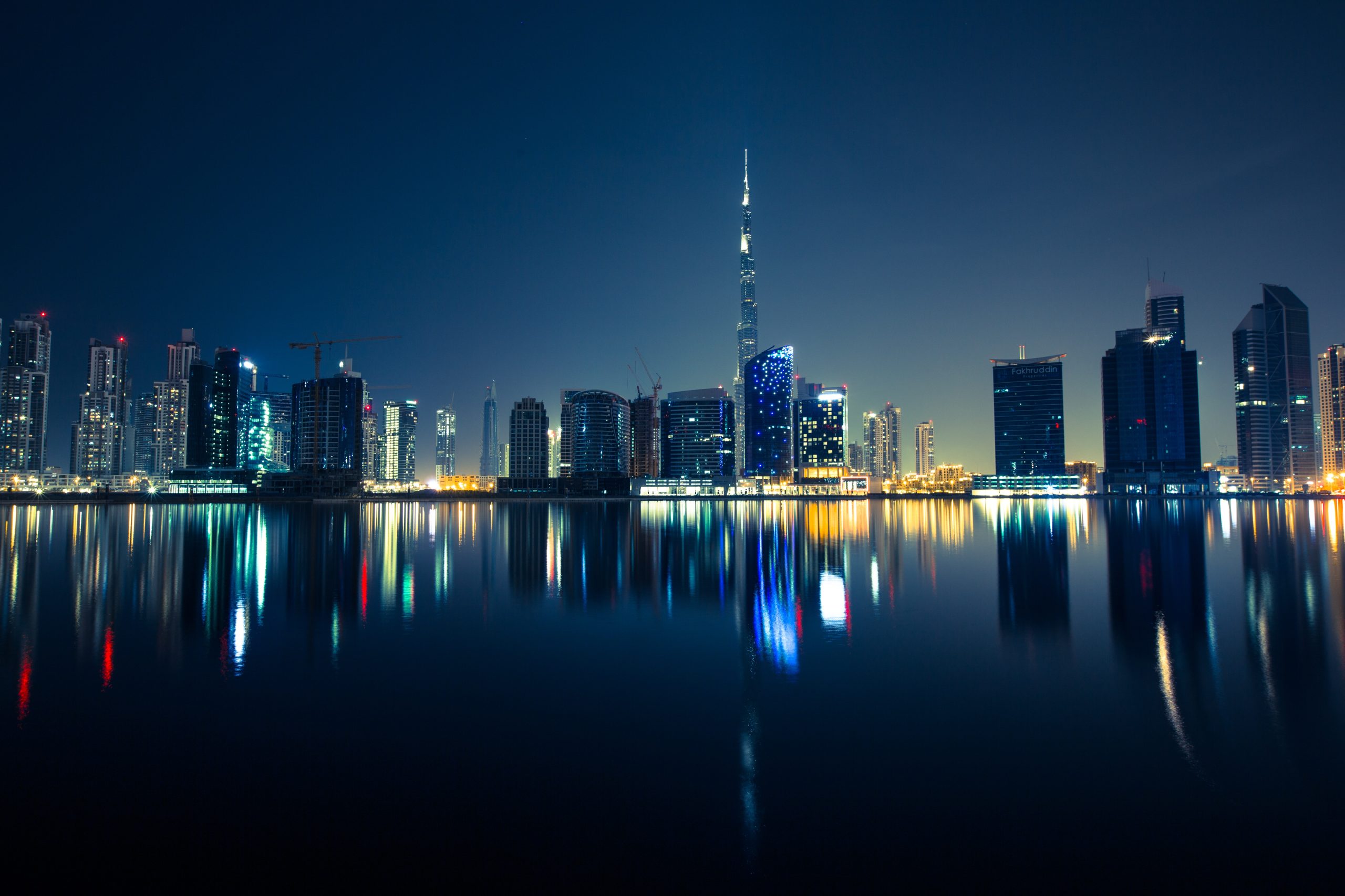 Illuminated Dubai skyline at night with dense residential and commercial towers, illustrating the city's rental market governed by RERA's Smart Rental Index for legal 2026 rent increases.